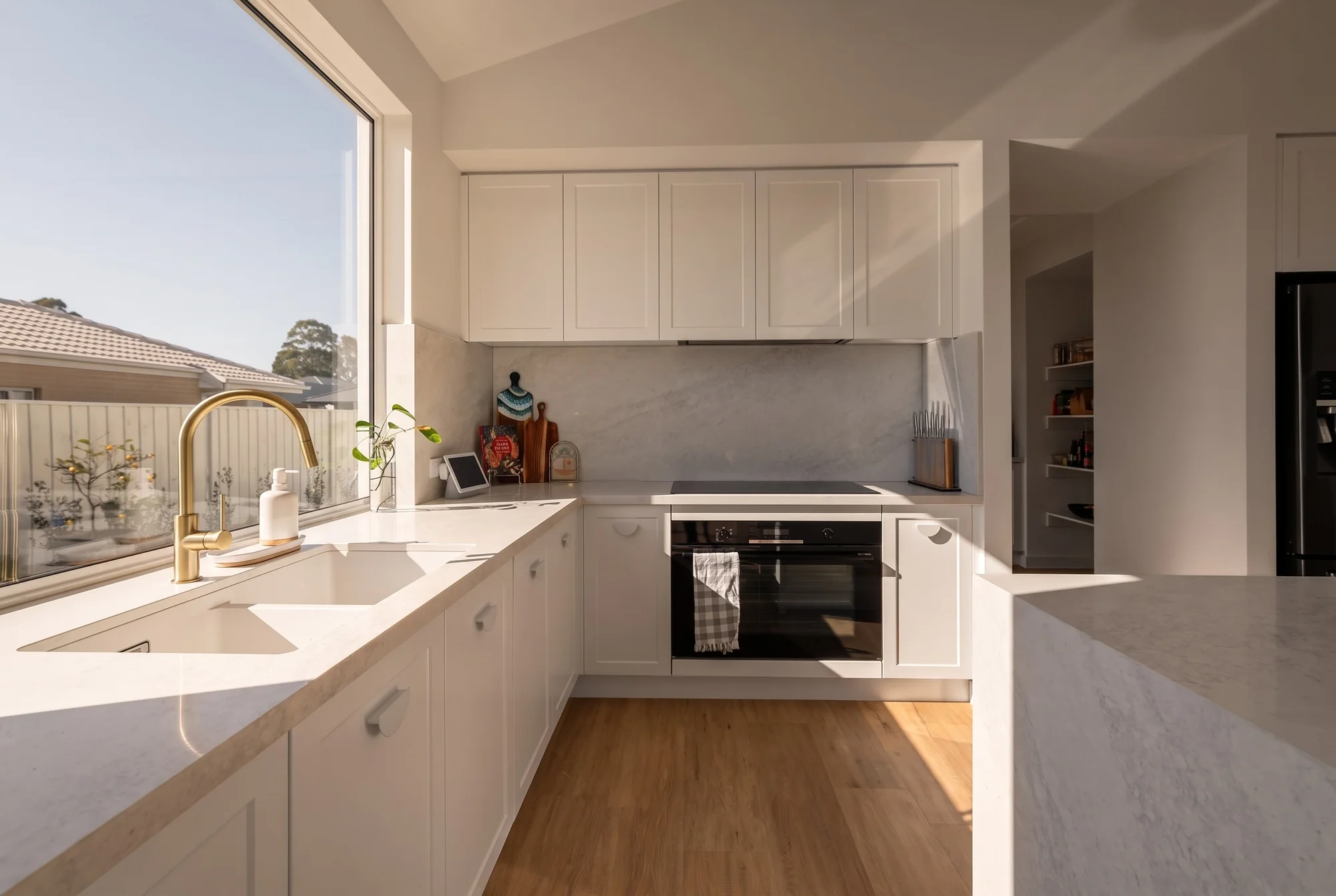Kitchen with stone benchtops and shaker cabinetry