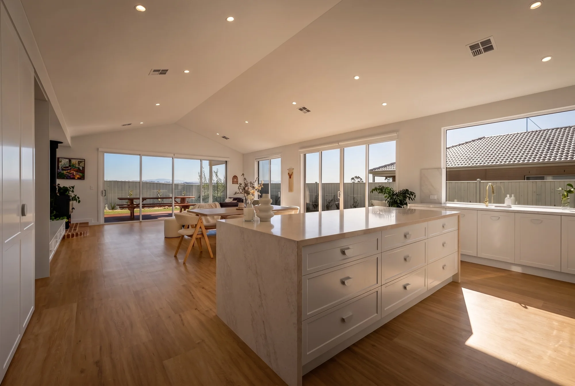 Kitchen island in stone with white shaker cabinetry